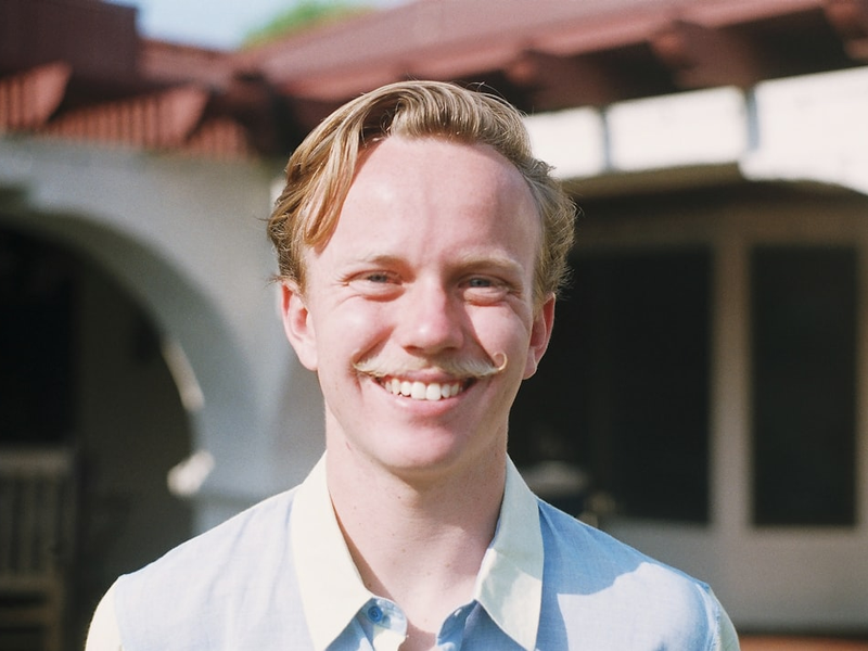 smiling man in white collared shirt