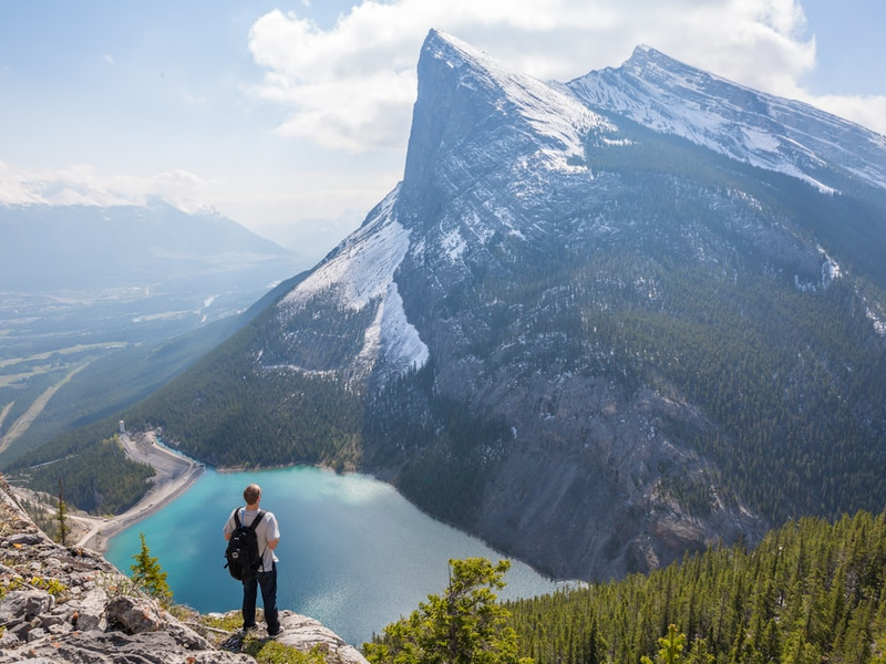 Backpacker on a high ledge