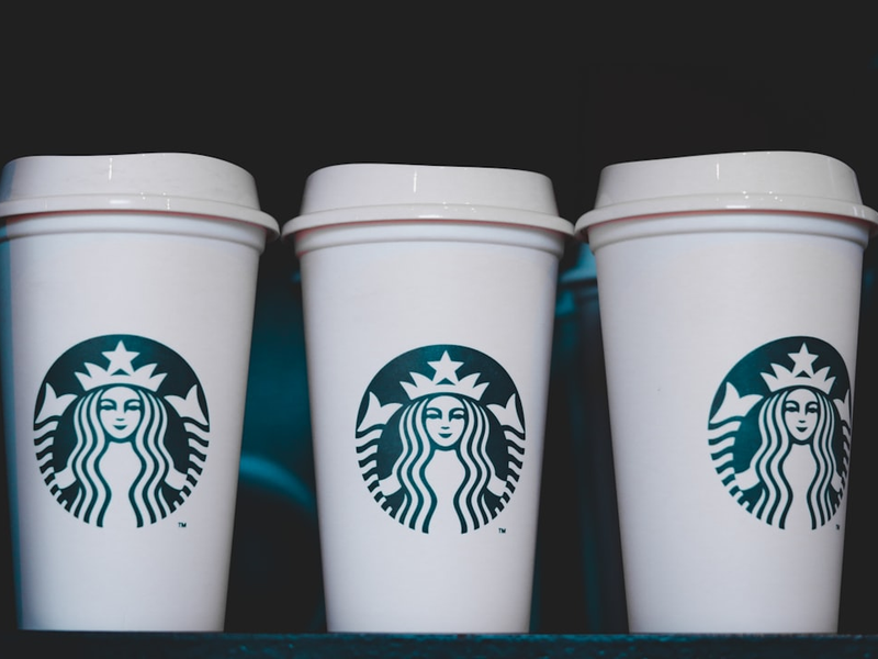 two white starbucks disposable cups