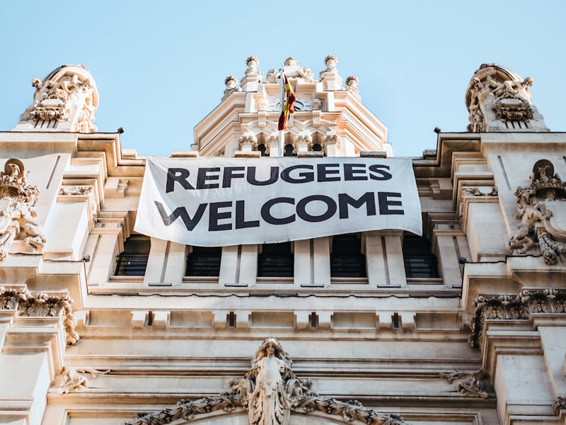 building with refugees welcome signage