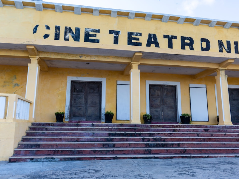 A yellow building with steps leading up to it