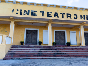 A yellow building with steps leading up to it
