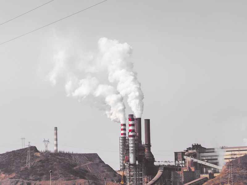 smoke comes out from industrial factory chimney