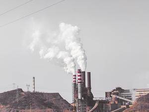 smoke comes out from industrial factory chimney