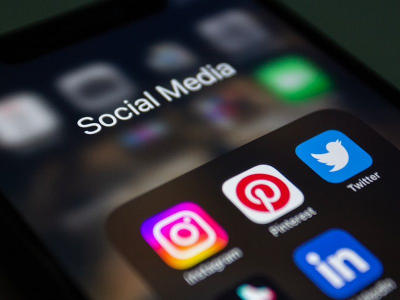 a close up of a cell phone with social media icons on it