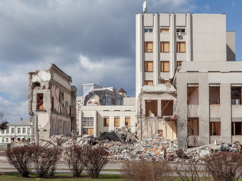 Buildings with missing walls, debris from destruction, AI photograph