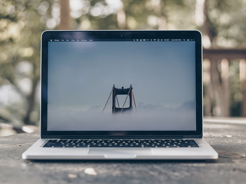 turned on MacBook Pro on gray surface