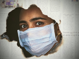 a woman wearing a face mask through a hole