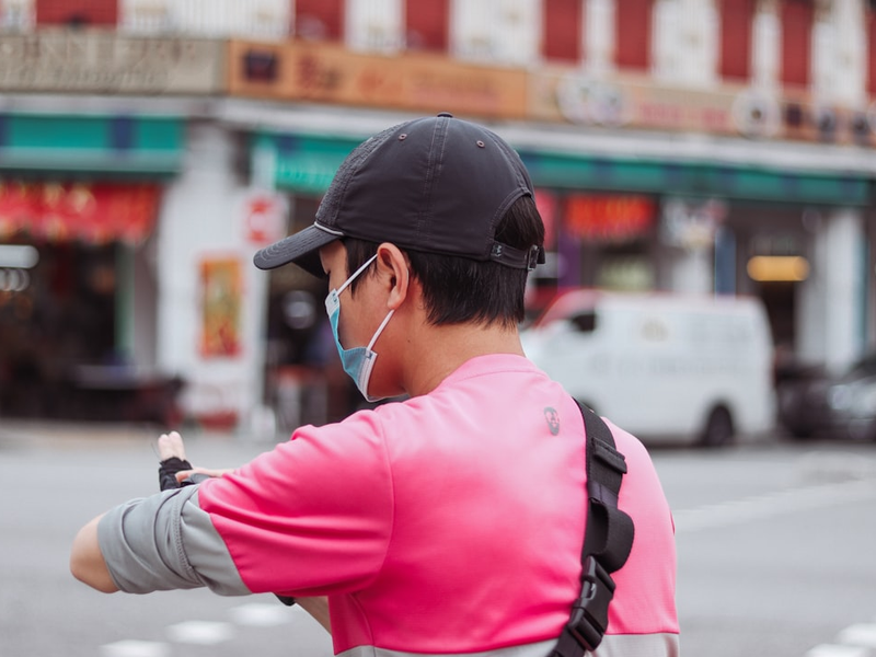 Singapore food panda delivery rider checking his watch