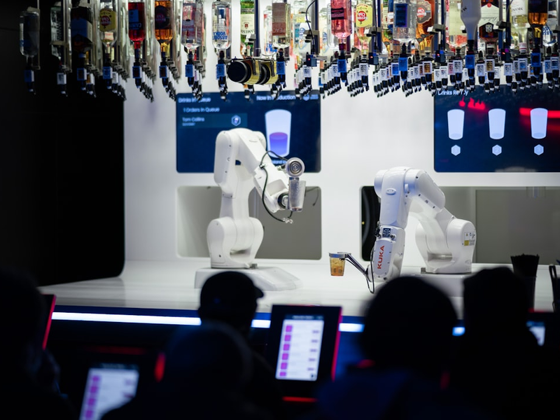 a group of people sitting in front of laptops