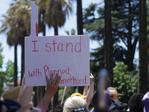 a group of people holding up signs in the air