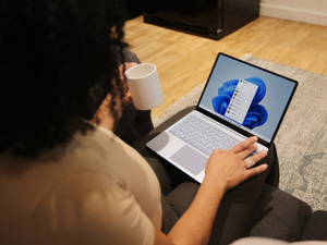 Female on her Microsoft laptop at work drinking coffee