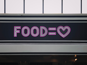 a neon sign that says foodie with a heart