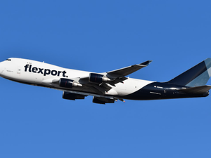 A large jetliner flying through a blue sky