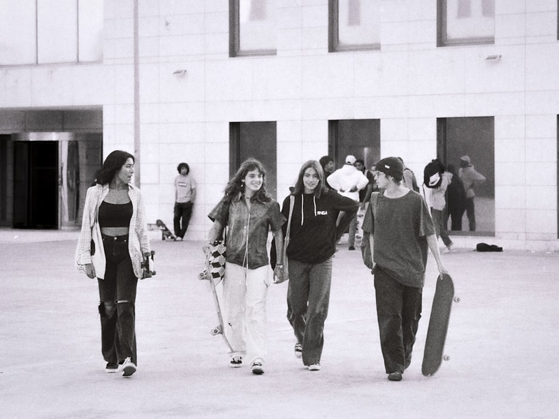 a group of young people walking down a street