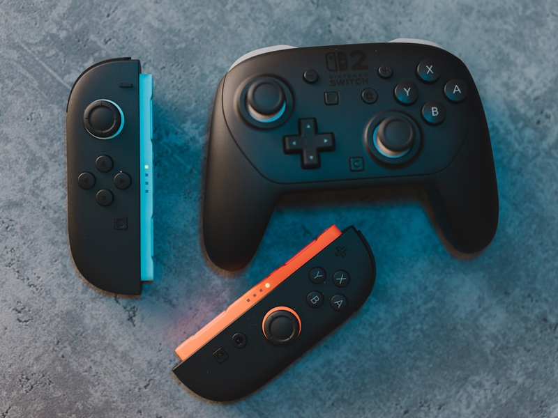 Different nintendo switch controllers on a surface.
