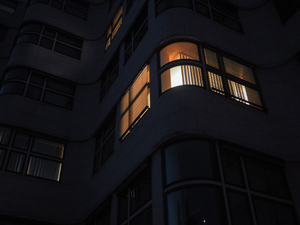 a tall building with windows lit up at night