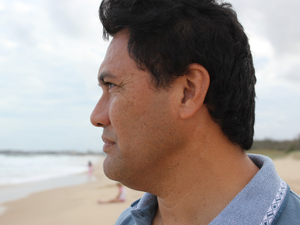 man looking at the beach water