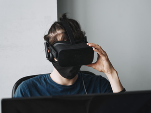 man in blue crew neck shirt wearing black vr goggles