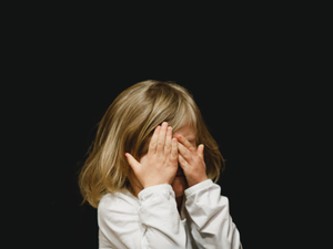 GIrl covering her face