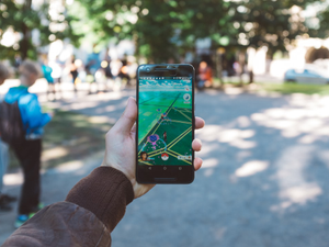 person playing Pokemon Go during daytime