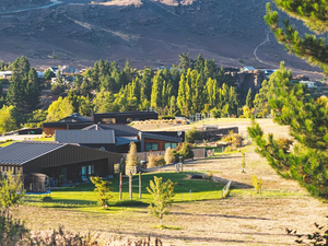 A view of a mountain range with houses in the foreground