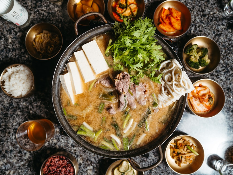 a bowl of soup with chopsticks on a table