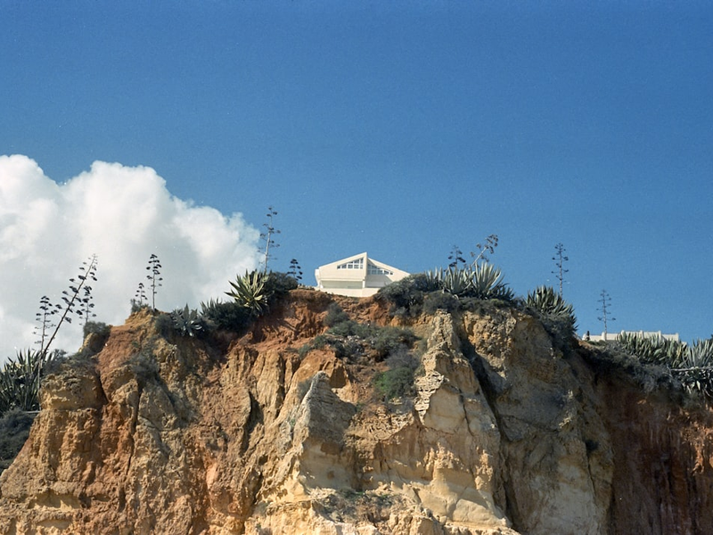 a white building on a rocky hill