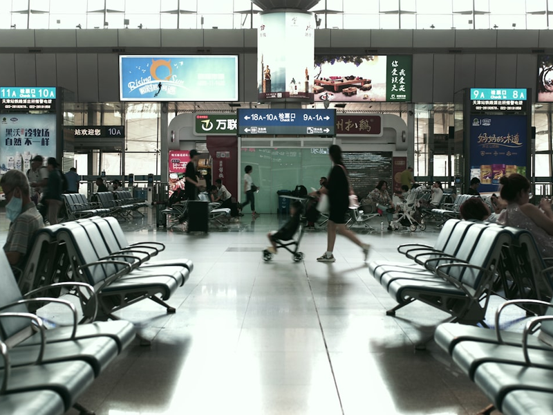 A group of people walking through an airport