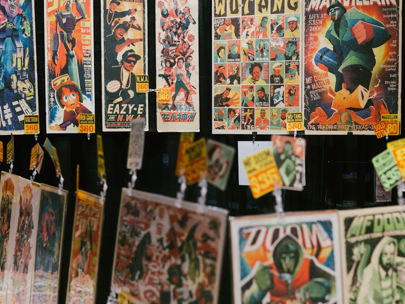 a bunch of posters hanging on a wall