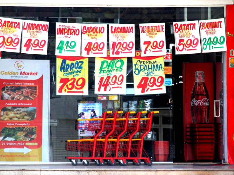 A grocery store window displaying price tags.