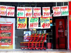 A grocery store window displaying price tags.