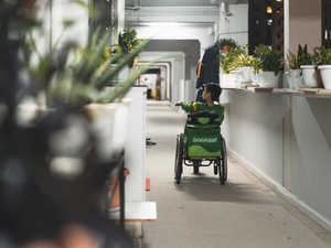 a person pushing a child in a stroller down a hallway