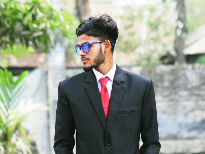 a man in a suit and tie wearing sunglasses