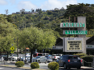 a parking lot with cars parked on the side of the road