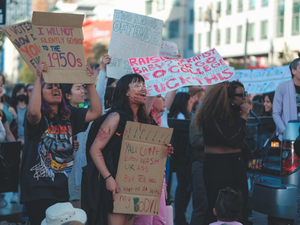 a group of people holding signs
