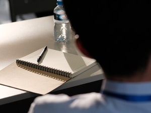 A student having his notebook prepared during a seminar in Vientiane, Laos