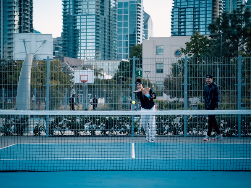 A man standing on a tennis court holding a racquet