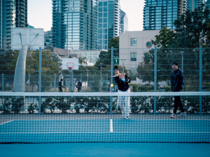 A man standing on a tennis court holding a racquet