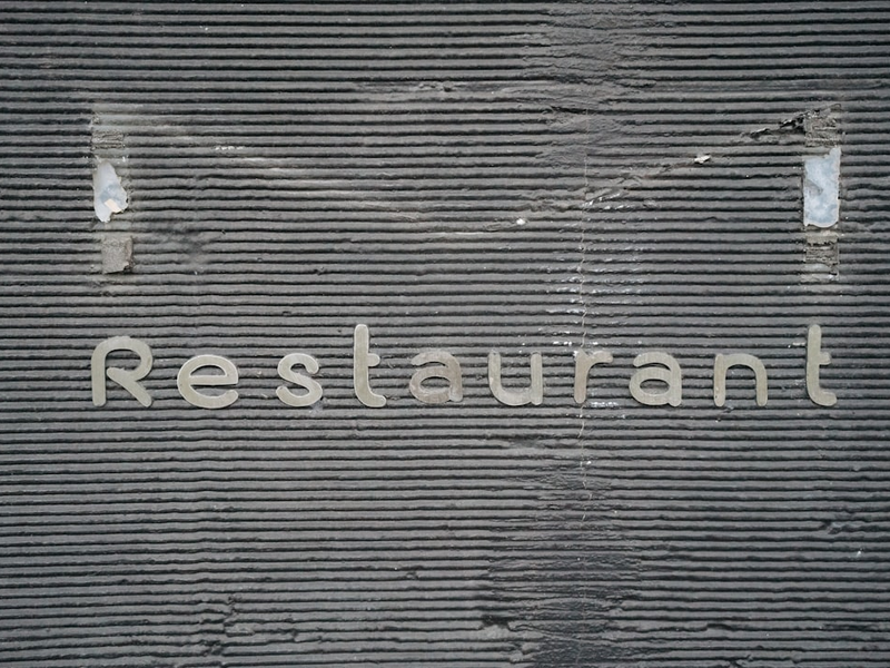 the word restaurant written on the side of a building