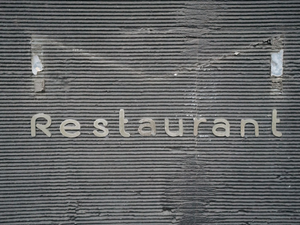 the word restaurant written on the side of a building
