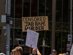 a group of people holding up signs in the street