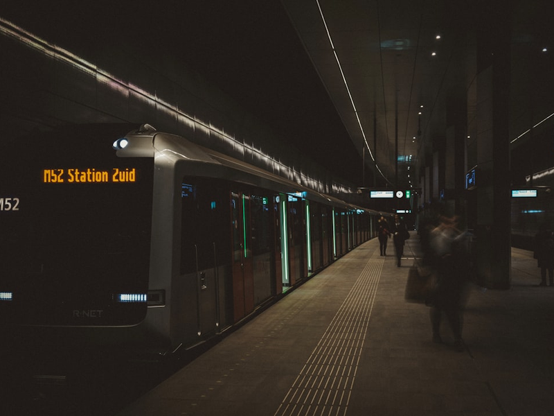 people standing beside train displaying M52 Station
