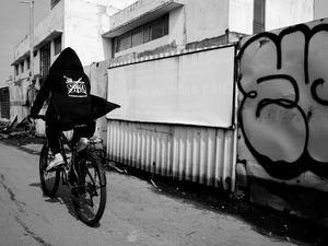 A person riding a bike down a street