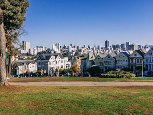white and gray concrete building near green trees under blue sky during daytime