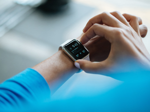 Young Indian man wearing Apple Watch