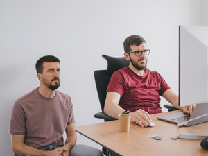 Two young entrepreneurs of a tech company discussing about projects.
