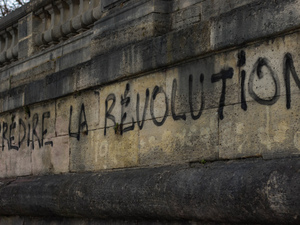 graffiti on the side of a building reads la revolution