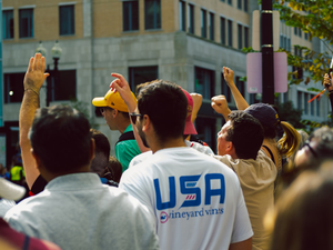 a crowd of people standing around each other