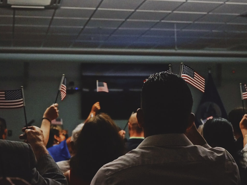 people holding flag of U.S.A miniature